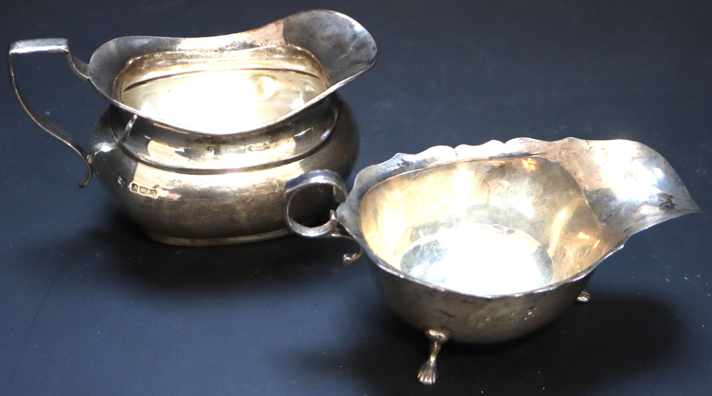 An Edwardian silver sauceboat, Chester, 1905 and a George V cream jug, gross 8oz.